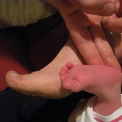 Glynn and Isla compare feet sizes.